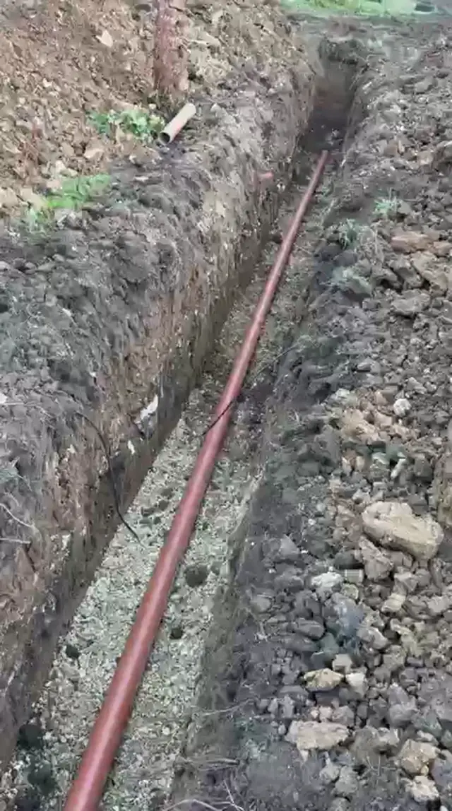 Underground drainage pipework laid in a prepared stone trench