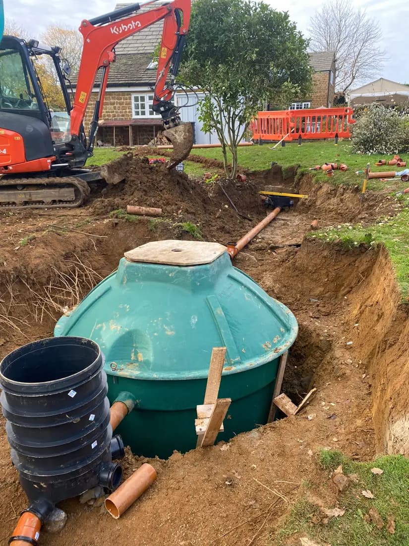 Underground tank, connecting drainage pipework and access chamber during installation